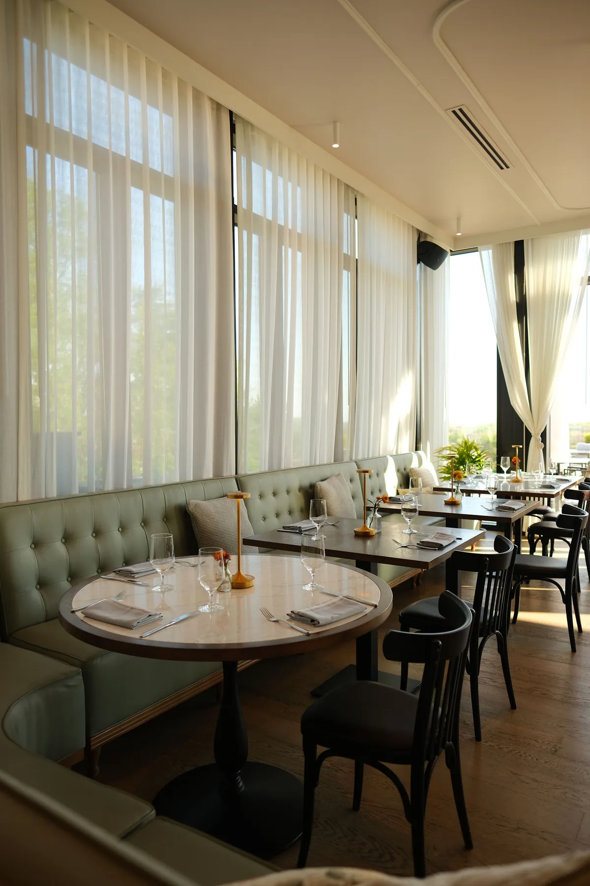 The dining room at Ladd's Tavern, banquettes along the window
